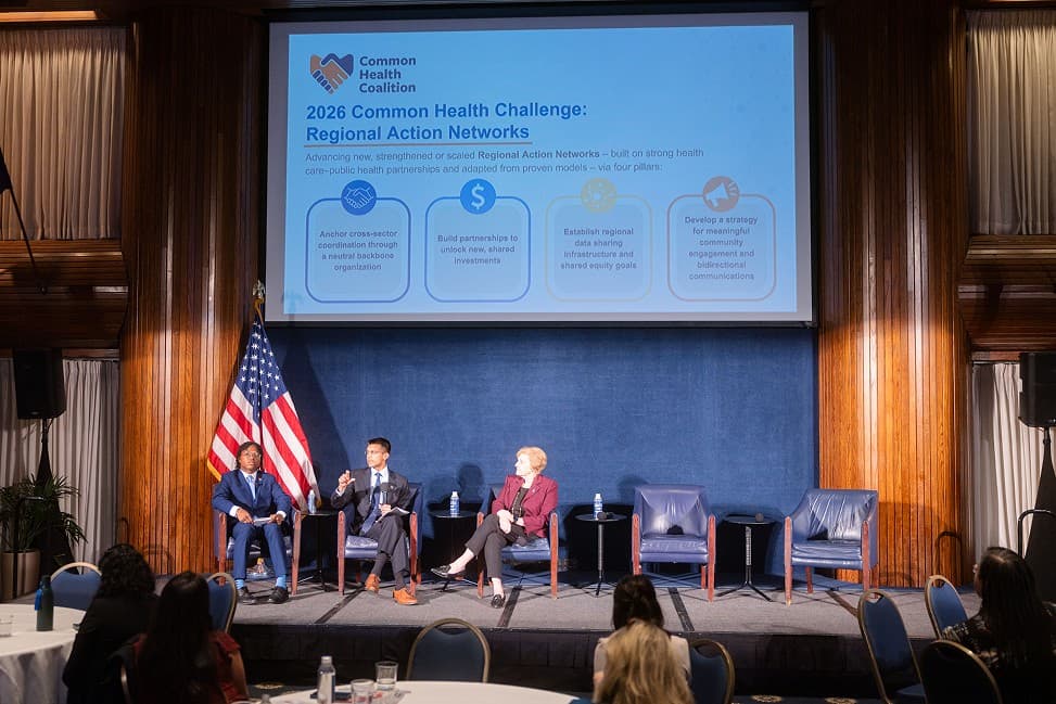 Panel discussion at an event with a slide on the 2026 Common Health Challenge and Regional Action Networks